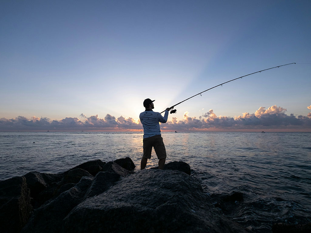 Man fishing on rocks