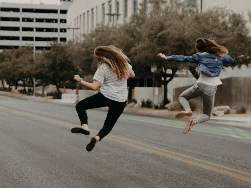 2 women kicking their feet