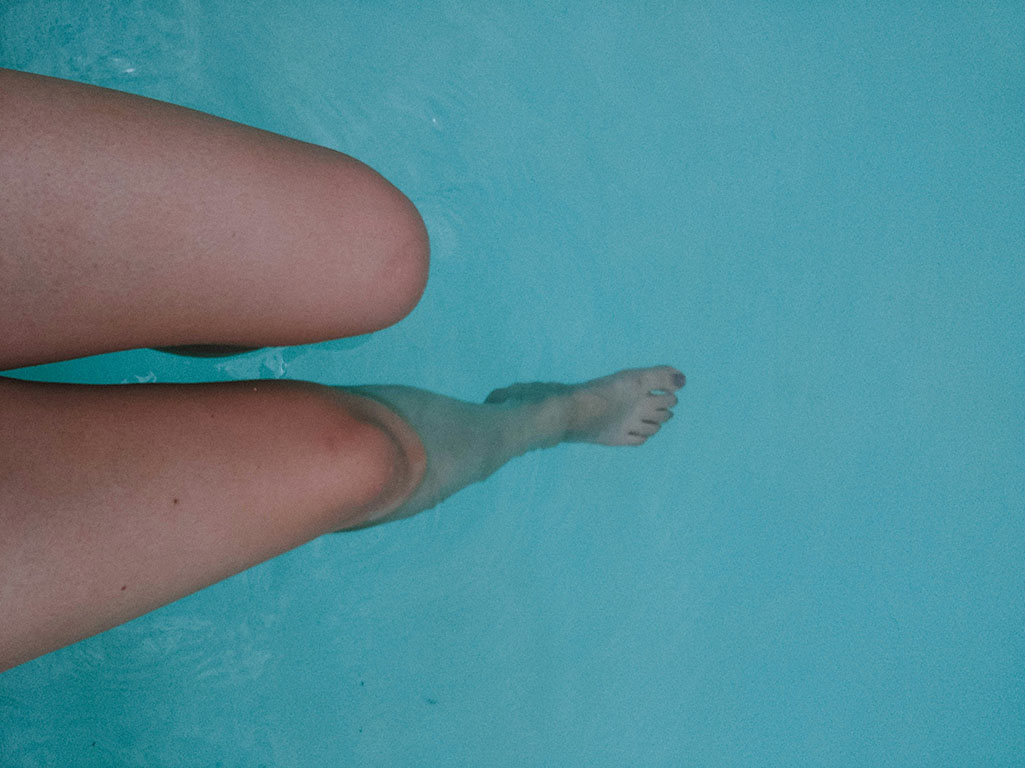 Legs submerged in water